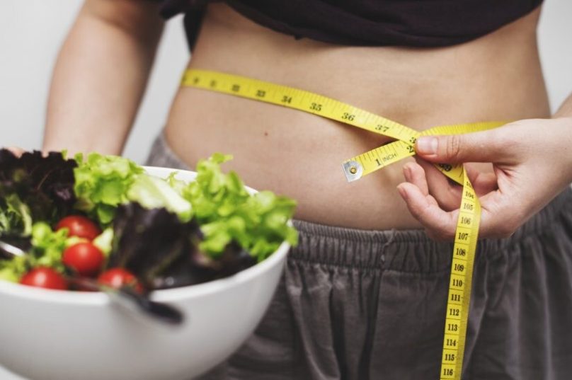 woman-measuring-her-tummy-weight-970x550